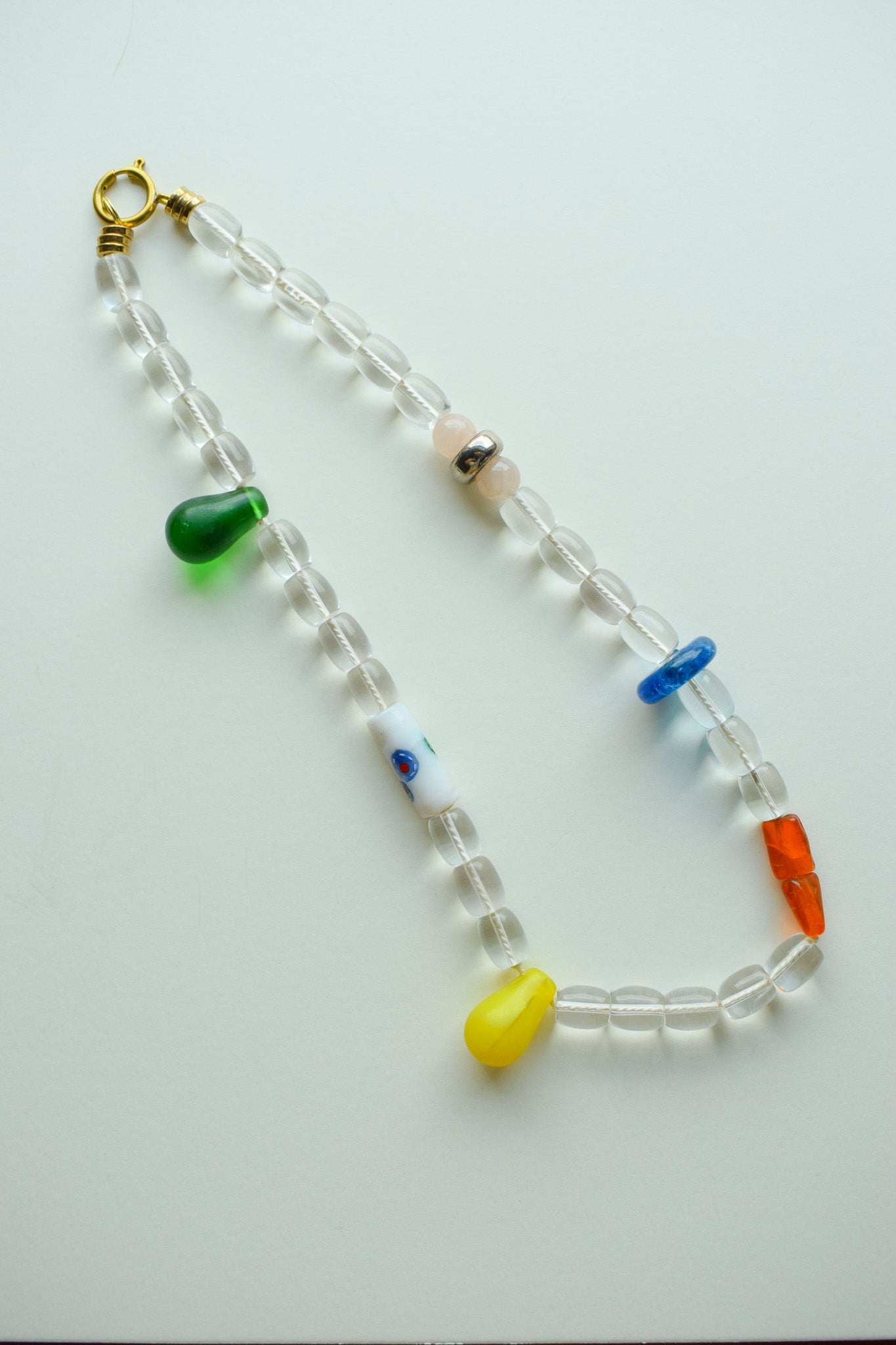 Beaded necklace with colorful beads on a white background