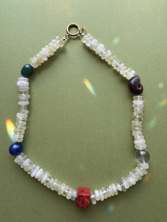 Beaded bracelet with colorful beads on a green background