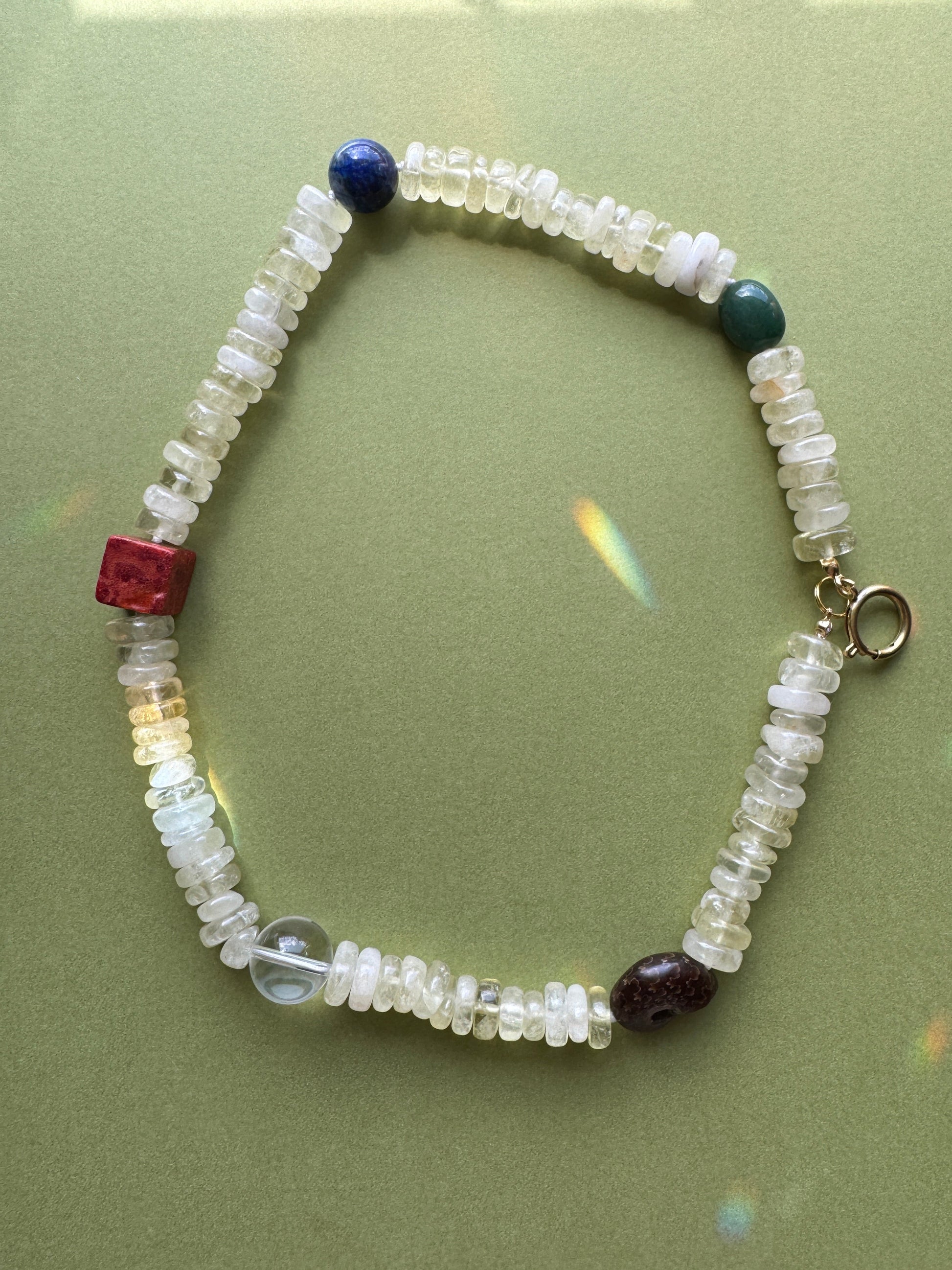 Beaded bracelet with multicolored beads on a green background