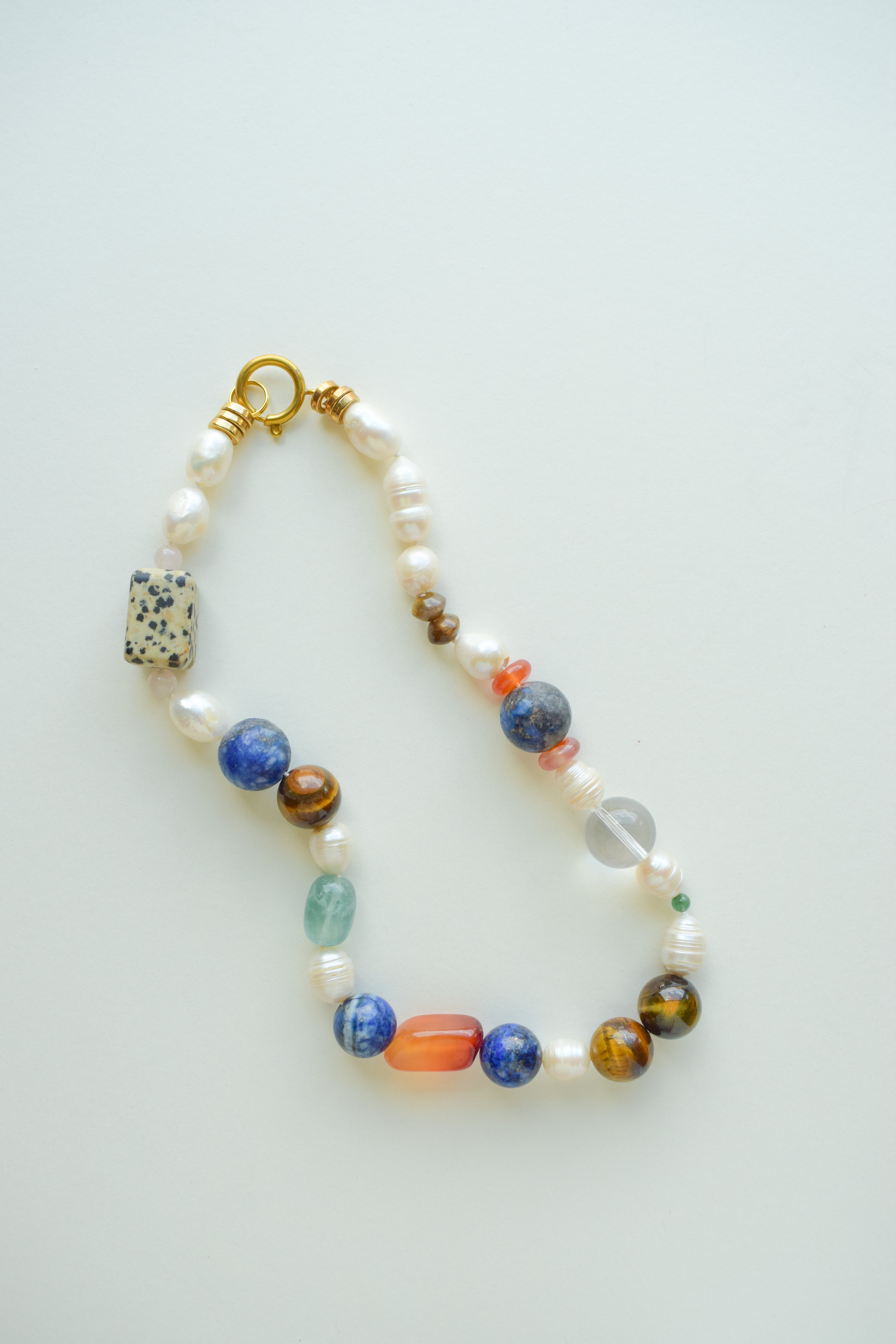 Multicolored beaded necklace on a light gray background